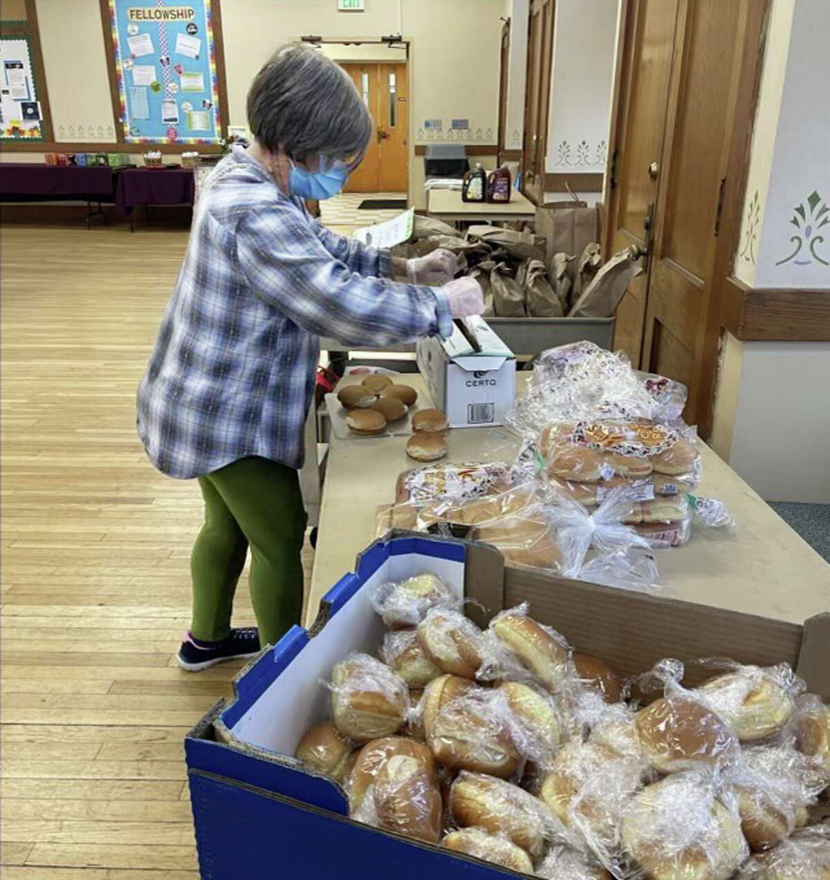 The late Julie Hurlburt, longtime organizer of the annual Christmas Day meal at First Church Middletown, prepares for a past event.