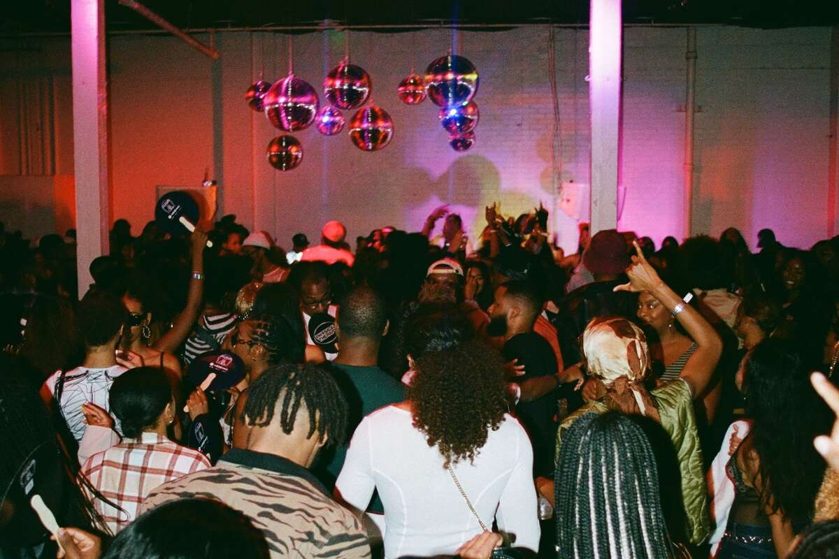 A crowd of people dancing at the PHYSICAL THERAPY party in Houston, Texas on Dec. 17, 2022. 
