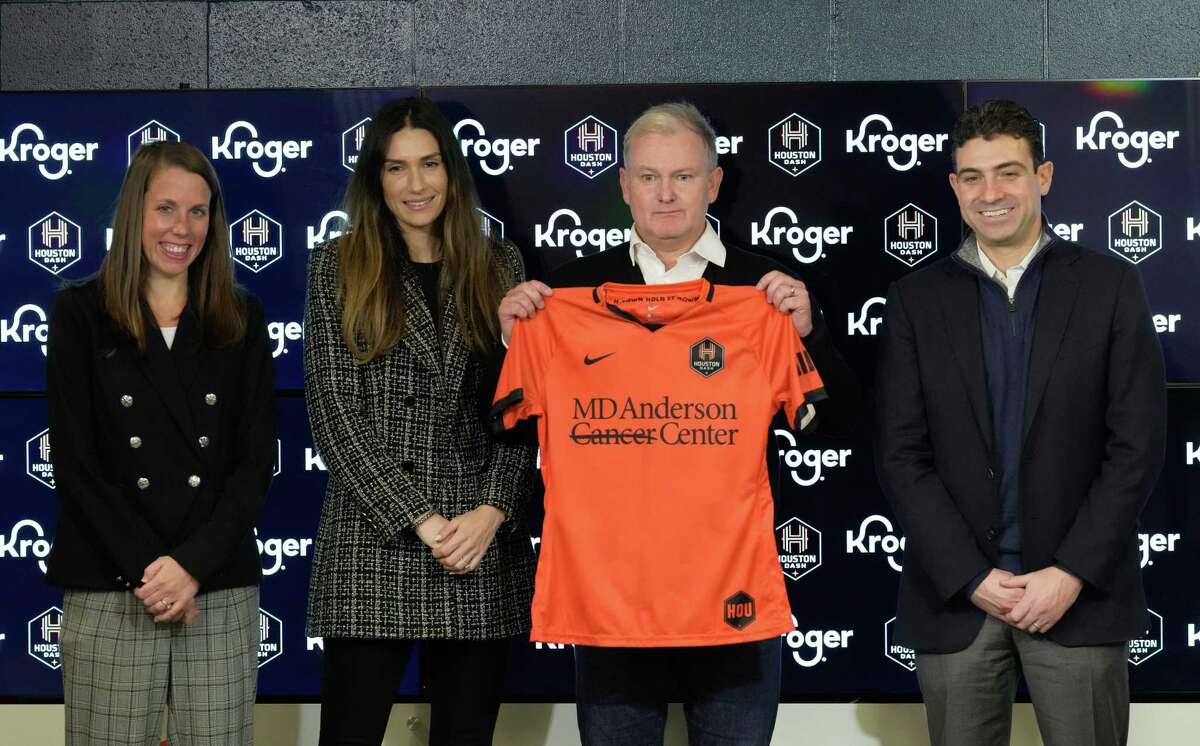 Houston Dash President Jessica O'Neil, from left, General Manager Alex Singer, new head coach Sam Laity and Majority Owner and Chairman Ted Segal pose for a photograph duing an introductory press conference Wednesday, Dec. 21, 2022, at PNC Stadium in Houston. Laity is the fourth head coach in the Dash history.
