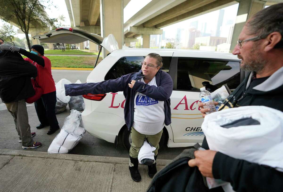 John Hall, Star of Hope outreach lawsuit  manager, 2nd  from left, fits a antheral   with a overgarment  arsenic  Sara Smith, center, tries connected  the overgarment  she received arsenic  the Star of Hope’s squad  members administer  blankets and coats from the “Love In Action” van to the stateless  up  of the arctic acold  beforehand   Wednesday, Dec. 21, 2022, successful  Houston. She and her partner, Timmy Barnes, right, who person  been stateless  for 9 months, some  received blankets, coats and different   items.