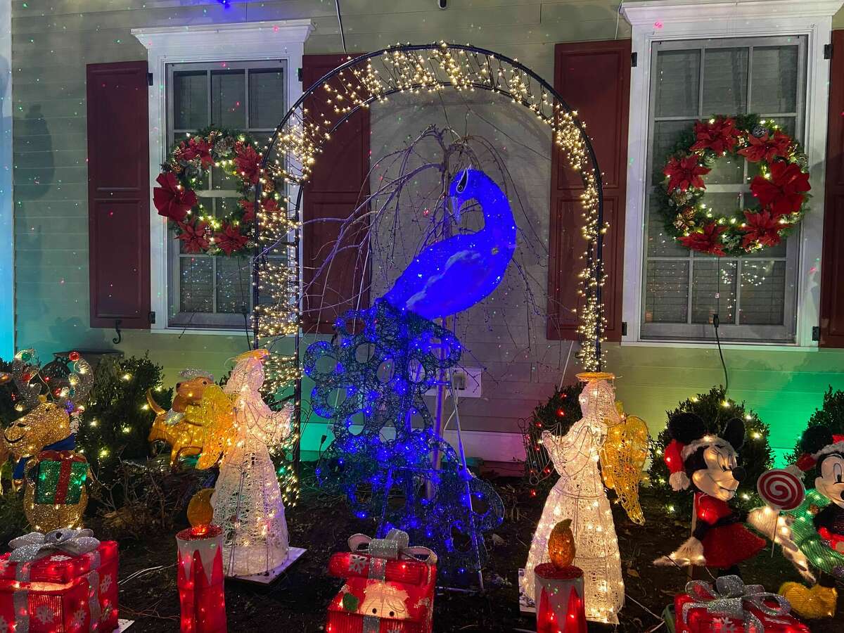 Karen Cingari bought a blue peacock to honor her mother, who decorated the wreaths on the windows.