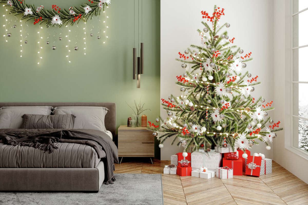 Christmas tree and presents in a modern bedroom.