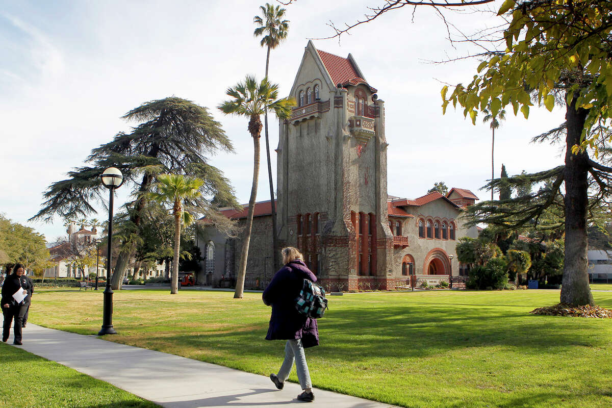 People walk past Tower Hall on the San Jose State University campus. 