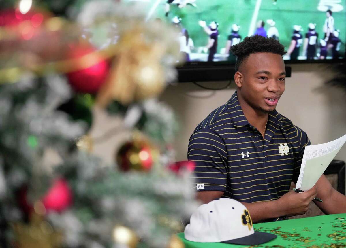 Kinkaid cornerback Micah Bell signs with Notre Dame during a celebration Wednesday in Cypress.