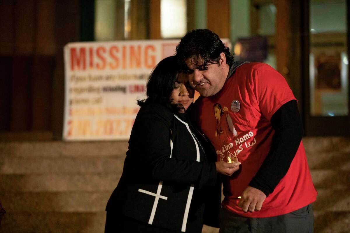 Riaz Sardar Khil, the father of Lina Sardar Khil, who went missing 1 year ago is hugged by Bexar County Clerk, Hon, Lucy Adame-Clark during a memorial for his daughter. The memorial, held on the courthouse steps marks one year that Kina has been missing.