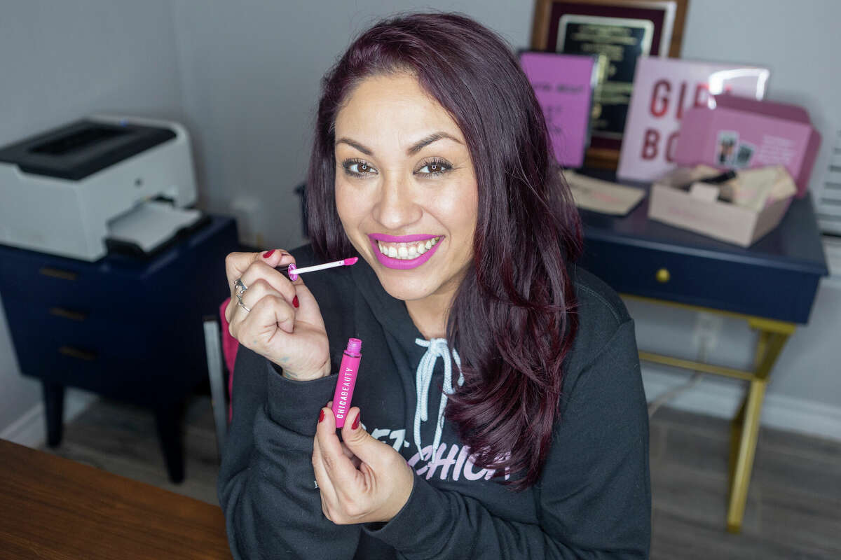 Makeup artist Kat Franklin poses Tuesday, Dec. 20, 2022 with one of the Chica Beauty lipstick colors she helped test. The company's owners, Toni Lee and Mei-Lon Jimenez, recently received a $25,000 grant from Bank of America and MasterCard during an appearance on the Jennifer Hudson Show to help grow the cosmetics company.