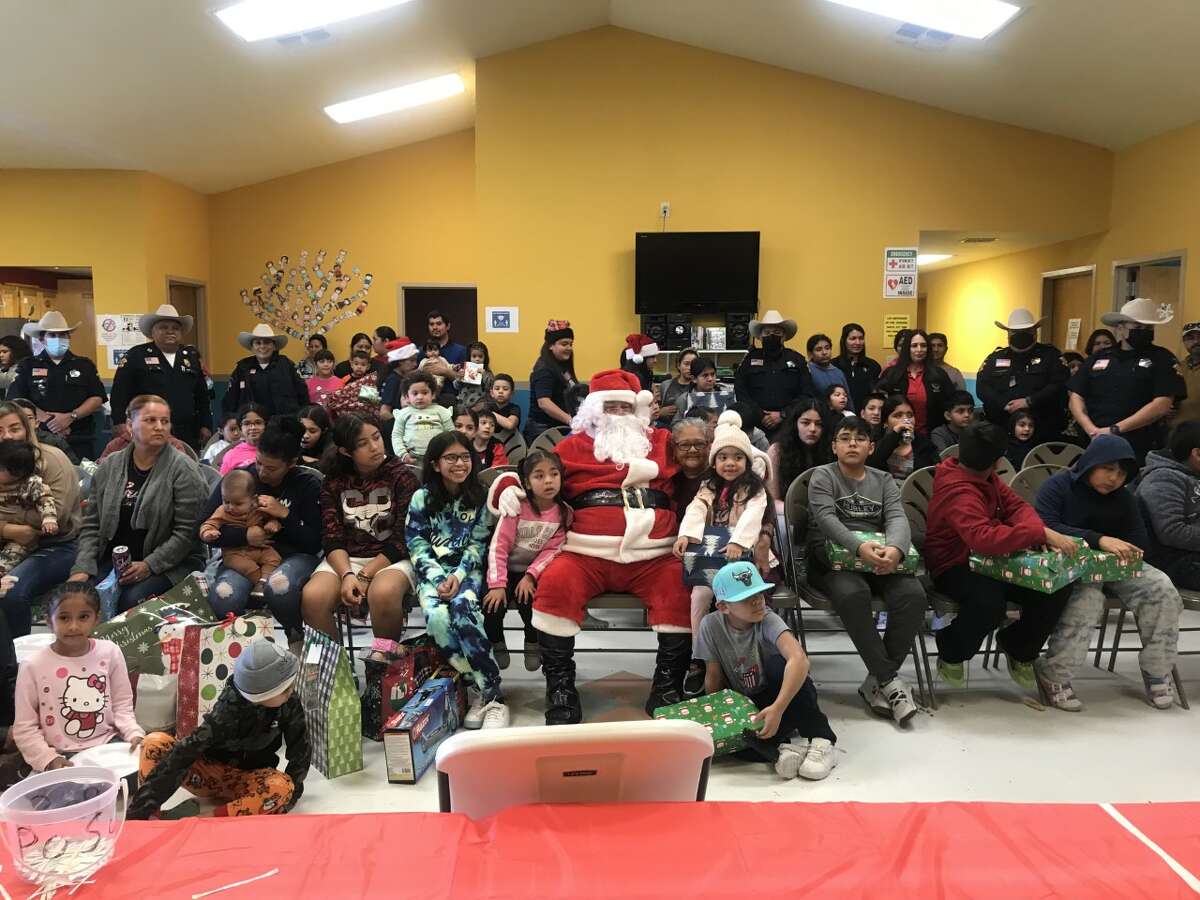 Webb County Constable Harold Devally distributes toys