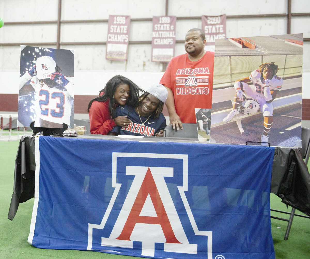 Legacy defensive back Canyon Moses receives a hug from his mother after signing with the University of Arizona football program on Dec. 21.