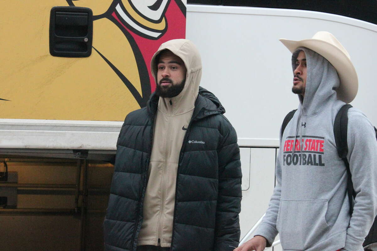 Braeden Childress (left) greets his brother Brandon Childress after the latter got off the Ferris bus on Sunday following the team's arrival from Texas.