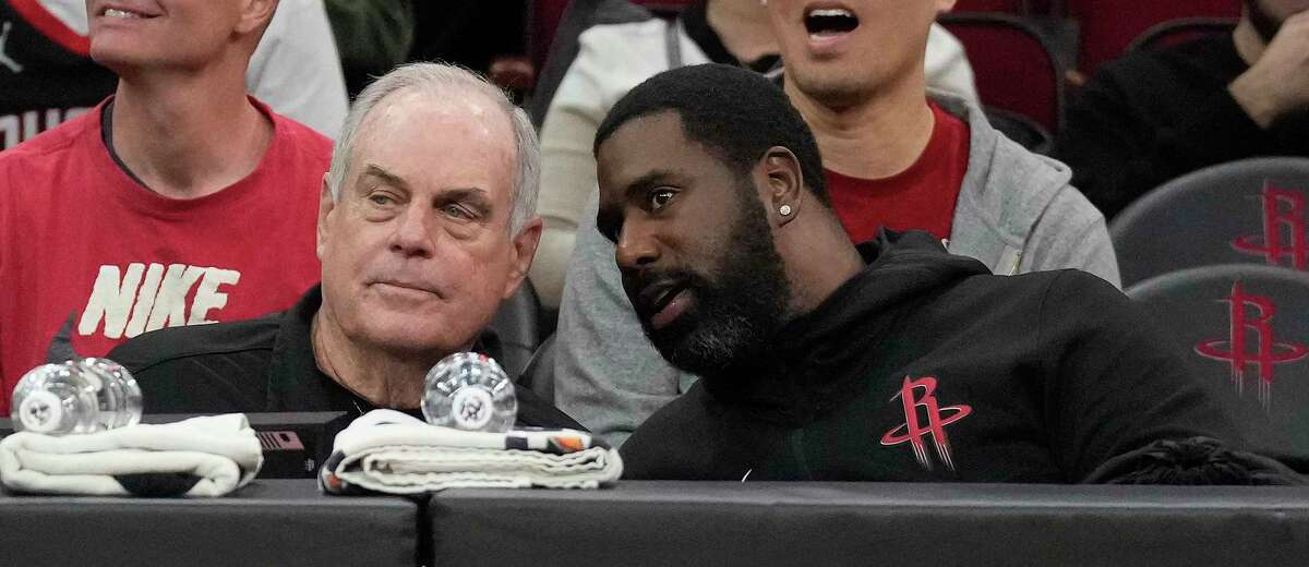 Robert Copley, left, talks with Desmond Jackson at the scorers table before the start of the first half of an NBA basketball game at Toyota Center on Wednesday, Dec. 21, 2022 in Houston.
