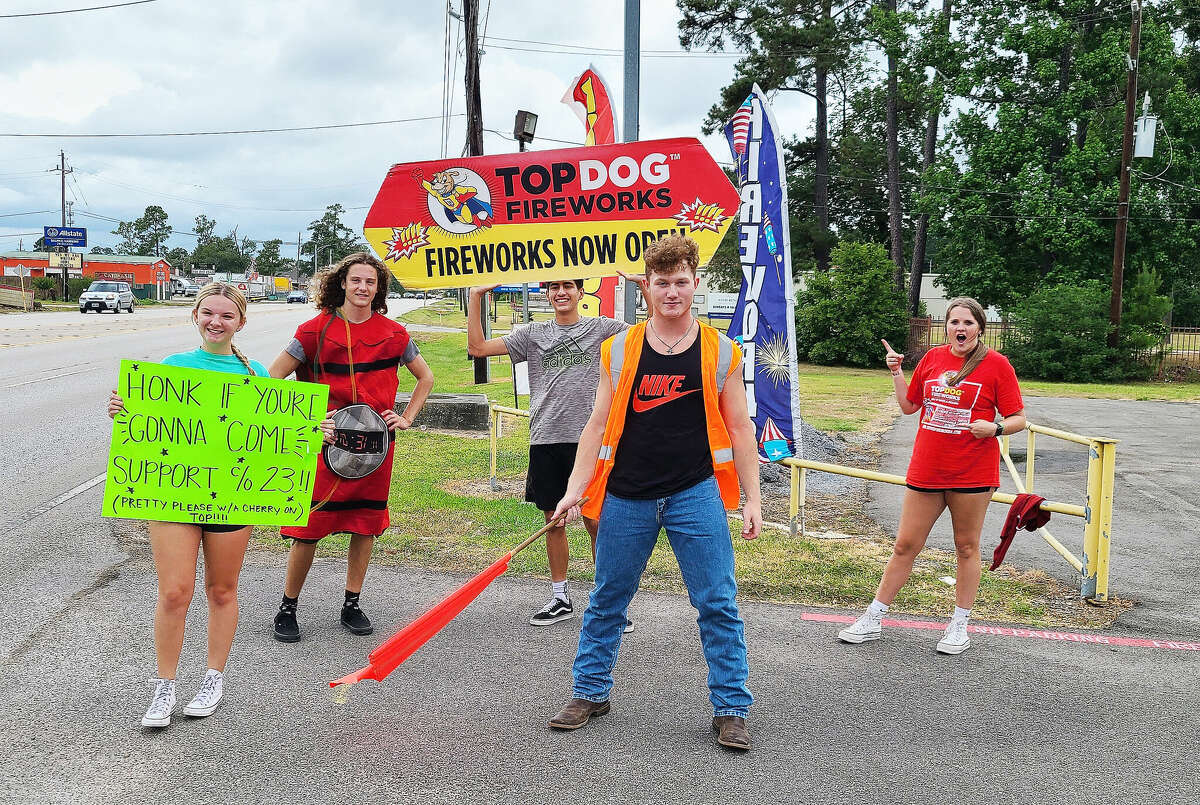 Hargrave High School students stand outside the Top Dog Fireworks Warehouse in Atascocita trying to flag down business last summer during the Fourth of July. Students are back selling now for the New Year's Eve celebrations.