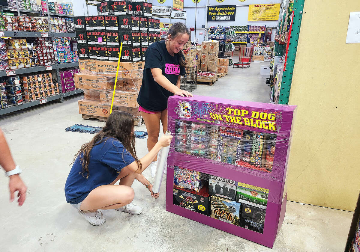 Hargrave High School students unpack merchandise at the Top Dog Fireworks Warehouse in Atascocita. The students operate the warehouse with adult supervision and raise funds for their Project Graduation.