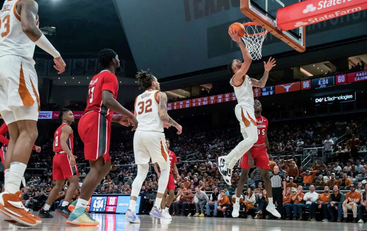 Texas forward Timmy Allen goes up for a shot against Louisiana-Lafayette forward Isaiah Richards (35) during the second half of an NCAA college basketball game, Wednesday, Dec. 21, 2022, in Austin, Texas. Texas won 100-72. (AP Photo/Michael Thomas)