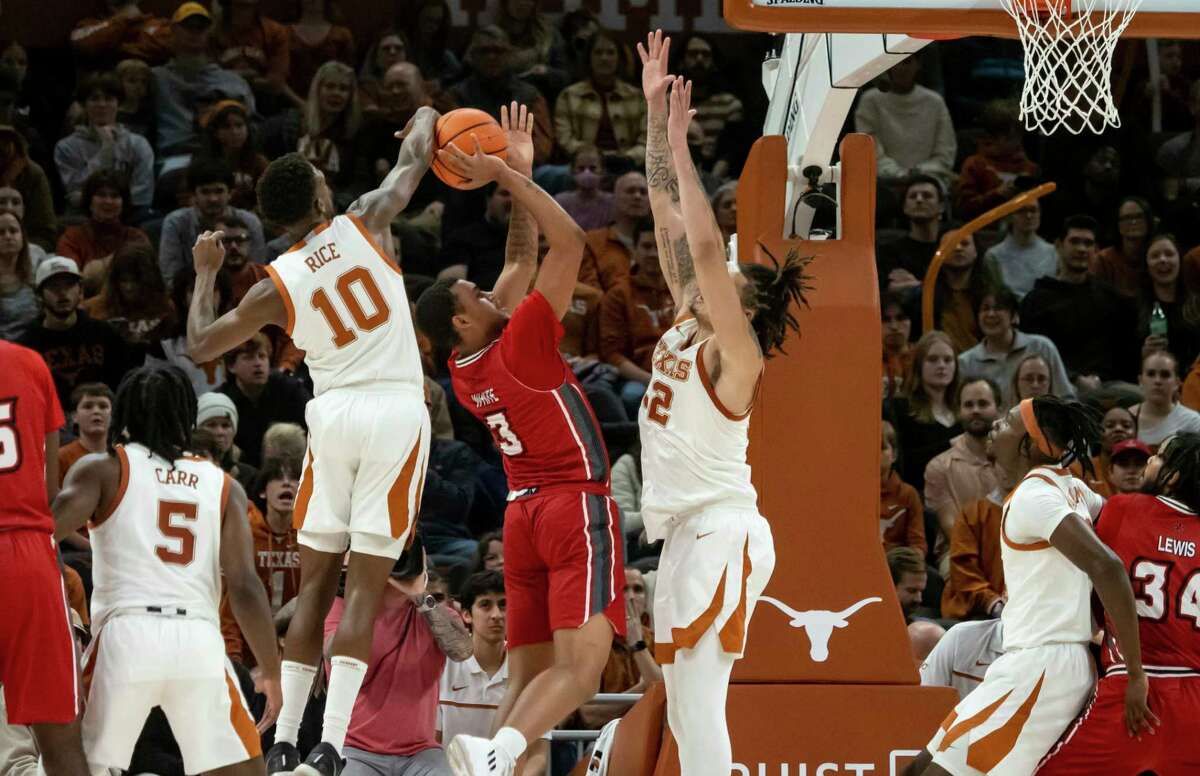 Texas guard Sir'Jabari Rice (10) blocks the shot of Louisiana-Lafayette guard Chancellor White (3) during the second half of an NCAA college basketball game, Wednesday, Dec. 21, 2022, in Austin, Texas. Texas won 100-72. (AP Photo/Michael Thomas)