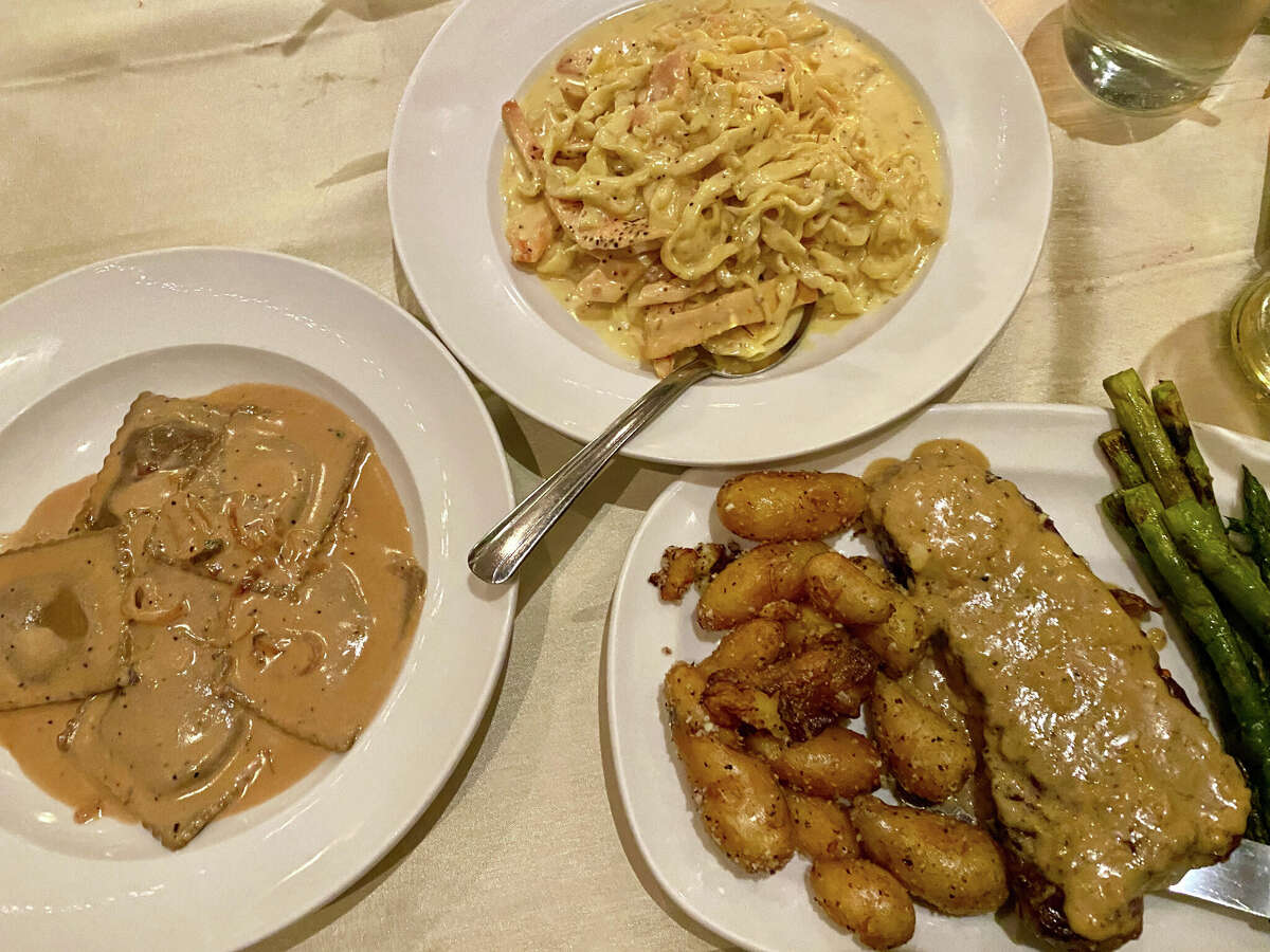 Entrees at Stella Pasta Bar, the latest incarnation of The Van Dyck building in Schenectady's Stockade, include, clockwise from left, mushroom ravioli, pasta with saffron cream sauce and strip steak with brandy-peppercorn sauce.