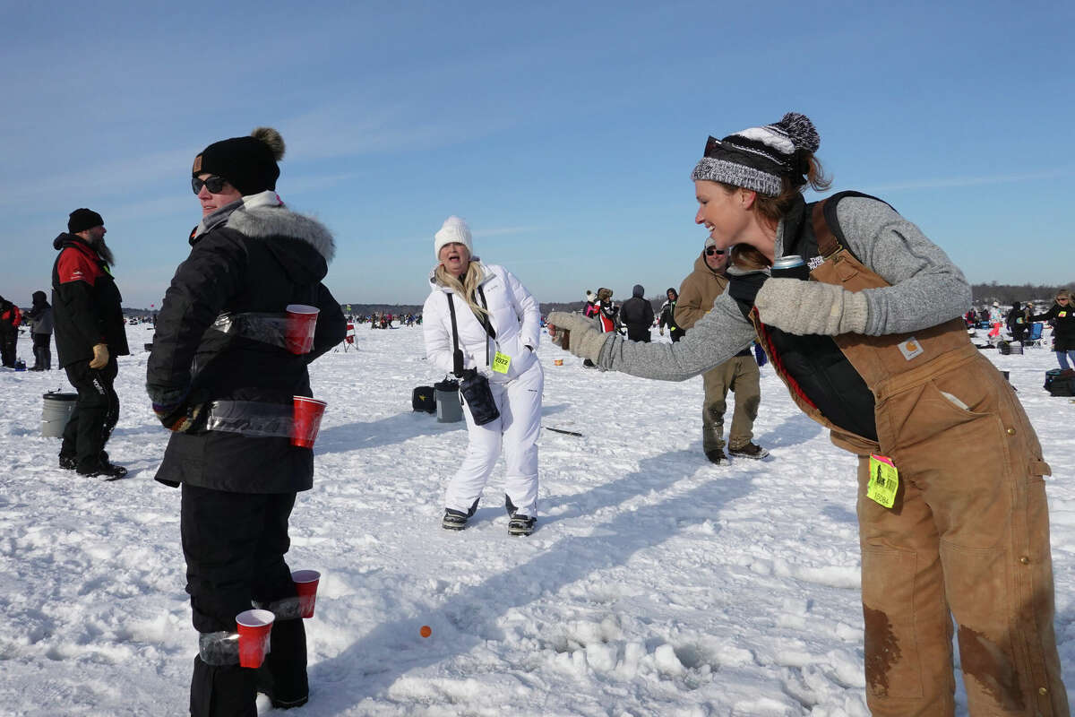 Fishermen play a modified version of beer pong while they compete in the Brainerd Jaycees Ice Fishing Extravaganza on January 29, 2022 in Brainerd, Minnesota. About 10,000 anglers were expected to compete in the tournament, which is billed as the "largest charitable ice fishing contest in the world".