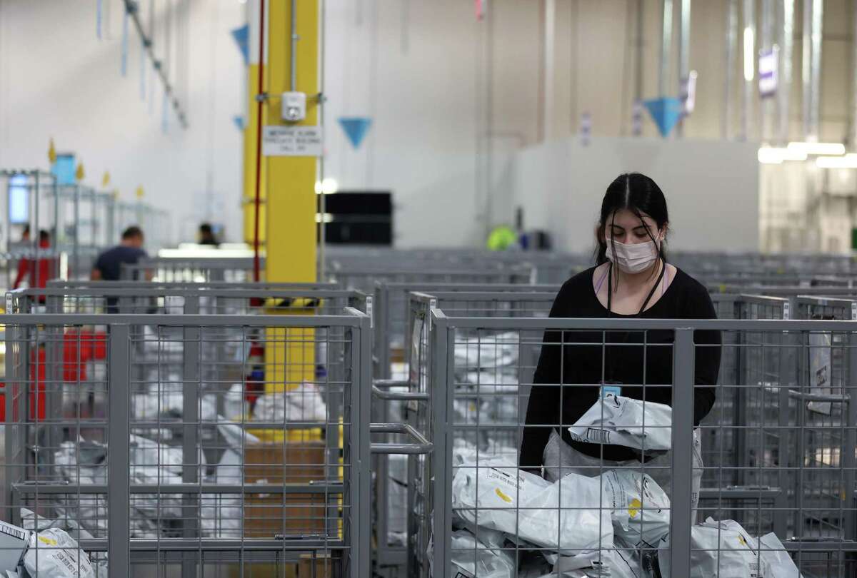 A worker sorts packages at a new Amazon same-day shipping facility in Richmond.