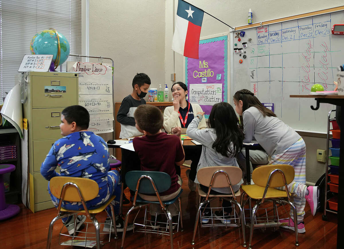 Angelina Castillo, an iEducate tutor, demonstrates how she works with third grade students on their math skills at Briscoe Elementary School on Tuesday, Dec. 20, 2022 in Houston.