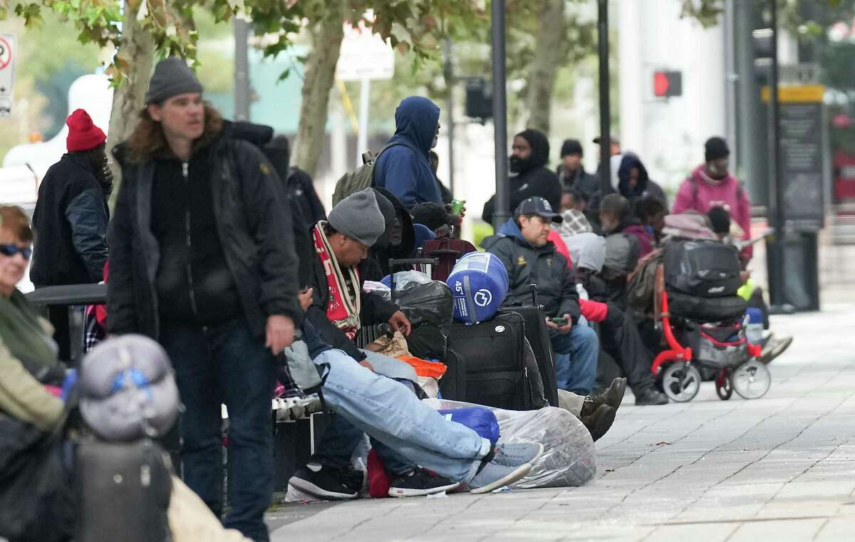 People enactment     up   extracurricular  the George R. Brown Convention Center earlier  the doors are unfastened  it its warming halfway  connected  Thursday, Dec. 22, 2022 successful  Houston. The metropolis  plans to support  the warming center, which has chairs, nary  cots, unfastened  until Saturday.