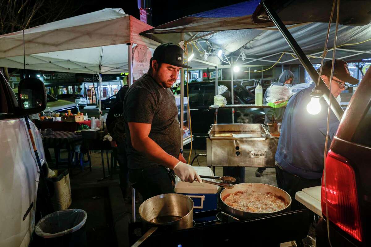 Edwin Mancilla fries chicken while serving Guatemalan food with his family a part of the food stand Shucos Magi in Fruitvale. Food is one of the most palpable ways to sense the presence of Guatemalans in the area, many of whom are Mam people, a Mayan subgroup from western Guatemala.