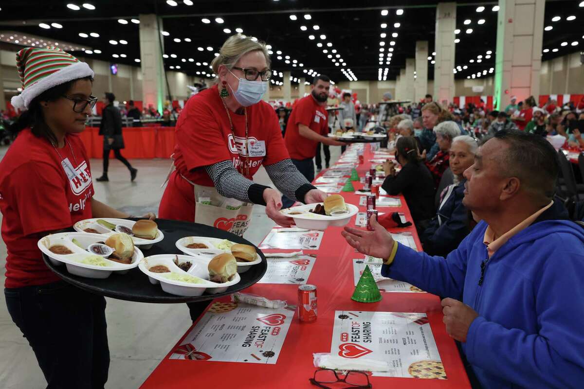 Thousands of volunteers, like Pamela Bartholomew, center, helped at the annual H-E-B Feast of Sharing at the Henry B. Gonzalez Convention Center, Thursday, Dec. 22, 2022. The event is one of 34 feasts hosted by H-E-B in Texas and Mexico. More that 250,000 meals were expected to be served at the feasts. In San Antonio, people were treated to smoke brisket and sausage dinners along with dessert and treats.