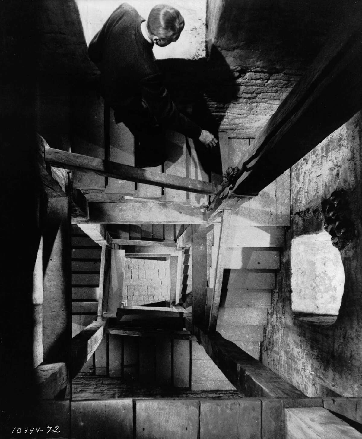 Actor James Stewart, as detective Scottie Ferguson, descends a spiral staircase in the film “Vertigo.”