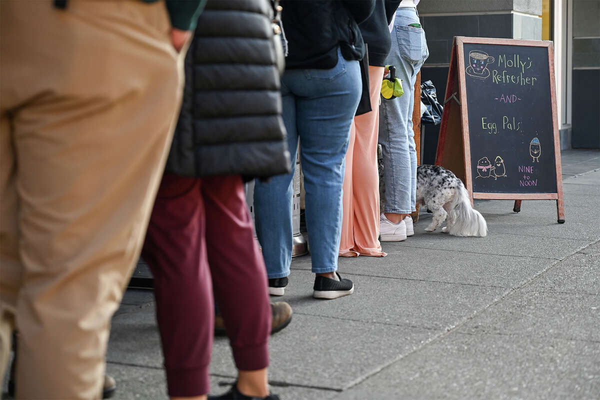 A line of customers wait in front of Ramen Shop for the new breakfast pop-up restaurant featuring Egg Pals and Molly's Refreshers in Oakland, Calif., on Sunday, Dec. 18, 2022.