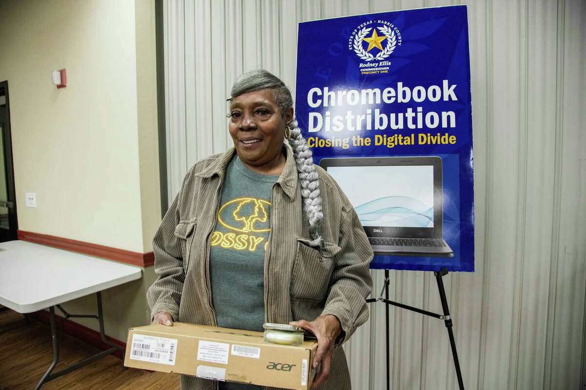 Third Ward resident Carelean Thomas receives a free Chromebook as part of a countywide program launched in February when the library system received funding from the American Rescue Plan Act to establish an internet connectivity campaign for Harris County residents on Thursday, Dec. 22, 2022 at Cuney Homes Community Center in Houston. “ After the winter storm last year, an entire room in my house was flooded, taking my old laptop with it. This will be the first time I will have a way to connect to the internet since then. “ she shares.