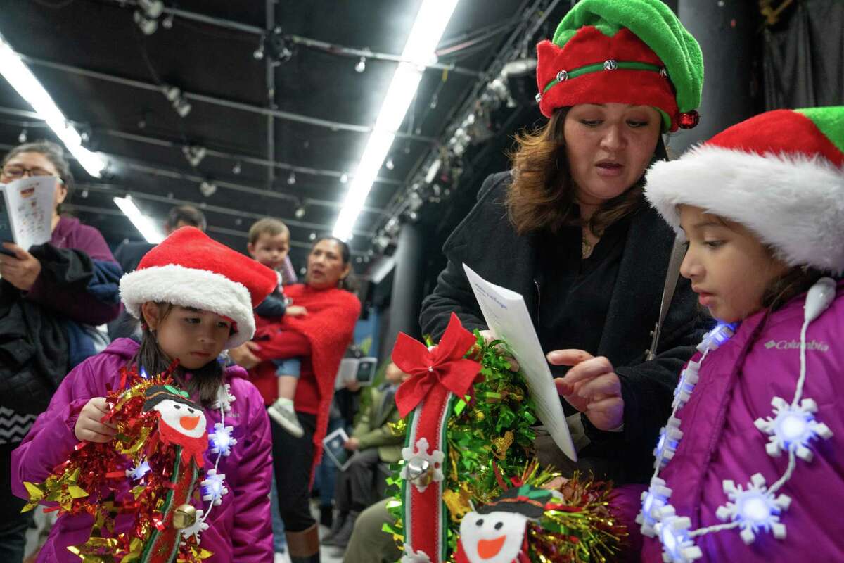 Sandra Urbina and her daughters Lucia Urbina,6, left and Sofia Urbina, 8, all from Houston, joined a small crowd for MECA’s annual Posada in Old Sixth Ward at the Historic Dow School in Houston, TX on December 14, 2022.