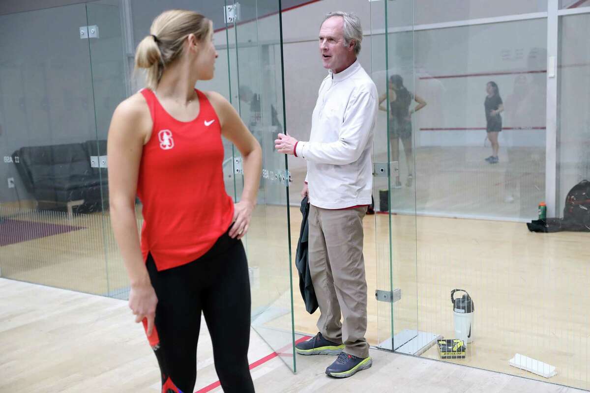 Stanford women’s squash co-captain Lucia Bicknell listens to head coach Mark Talbott during practice in Stanford this month.