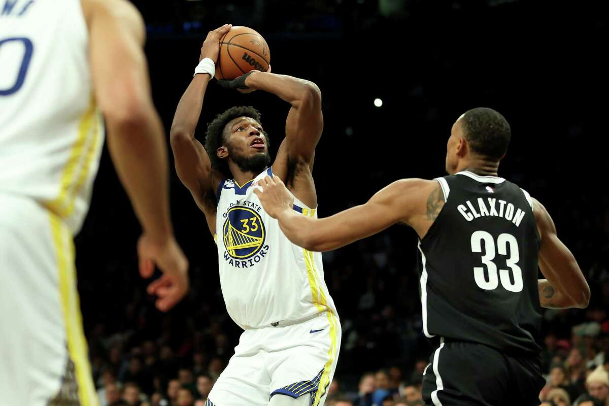 NEW YORK, NEW YORK - DECEMBER 21: James Wiseman #33 of the Golden State Warriors shoots the ball against Nic Claxton #33 of the Brooklyn Nets during the second half of the game at Barclays Center on December 21, 2022 in the Brooklyn borough of New York City. NOTE TO USER: User expressly acknowledges and agrees that, by downloading and or using this photograph, User is consenting to the terms and conditions of the Getty Images License Agreement. (Photo by Sarah Stier/Getty Images)