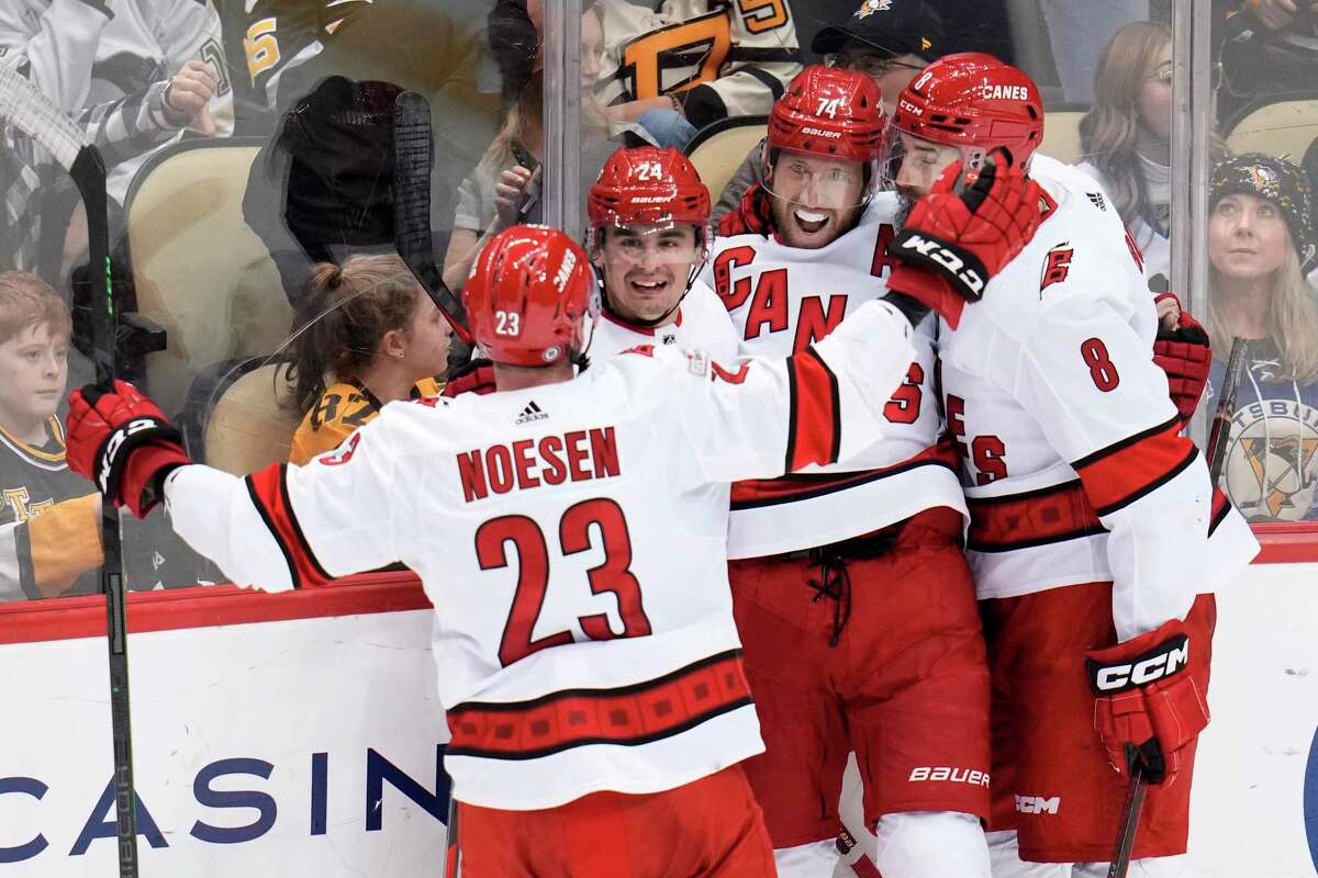 Carolina’s Jaccob Slavin is surrounded after his overtime goal gave the Hurricanes their seventh consecutive victory. Pittsburgh had won eight of nine, the lone loss coming against Carolina.