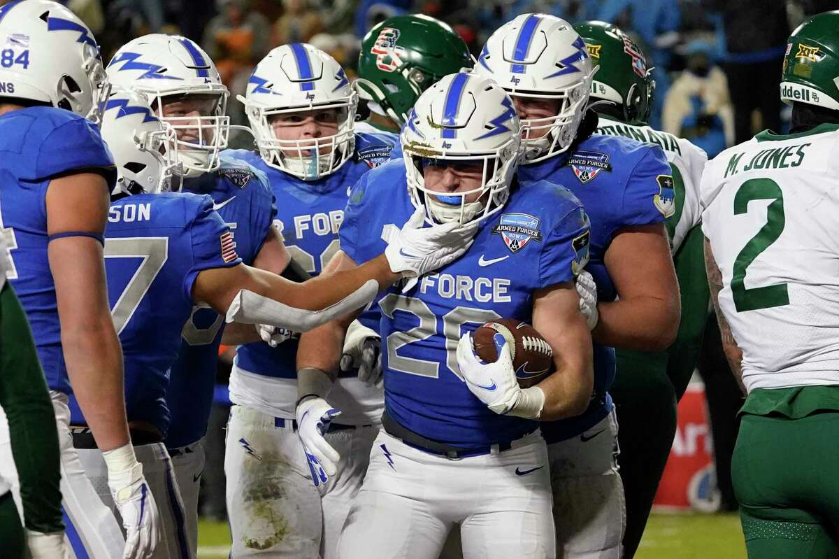 Air Force running back Brad Roberts (20) is congratulated by teammates after scoring a touchdown against Baylor during the first half of the Armed Forces Bowl NCAA college football game in Fort Worth, Texas, Thursday, Dec. 22, 2022.
