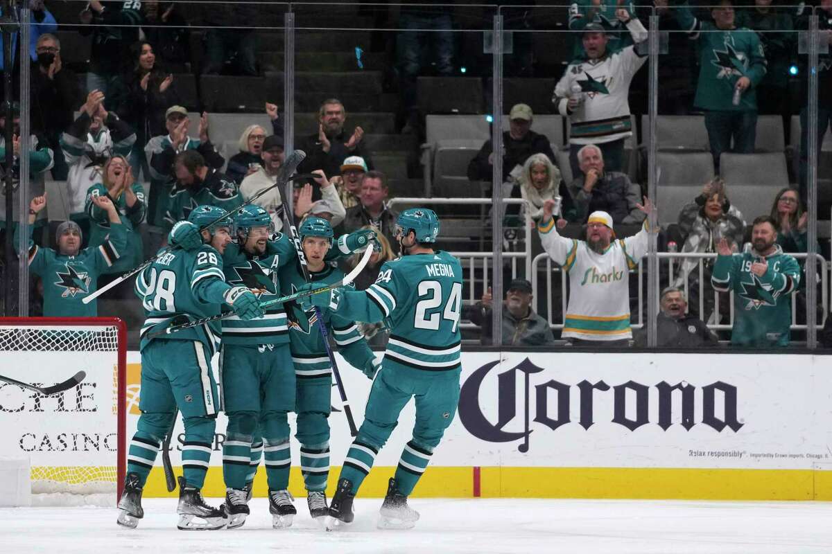 San Jose Sharks defenseman Erik Karlsson, second from left, celebrates with teammates after scoring a goal against the Minnesota Wild during the first period of an NHL hockey game in San Jose, Calif., Thursday, Dec. 22, 2022. (AP Photo/Godofredo A. Vásquez)