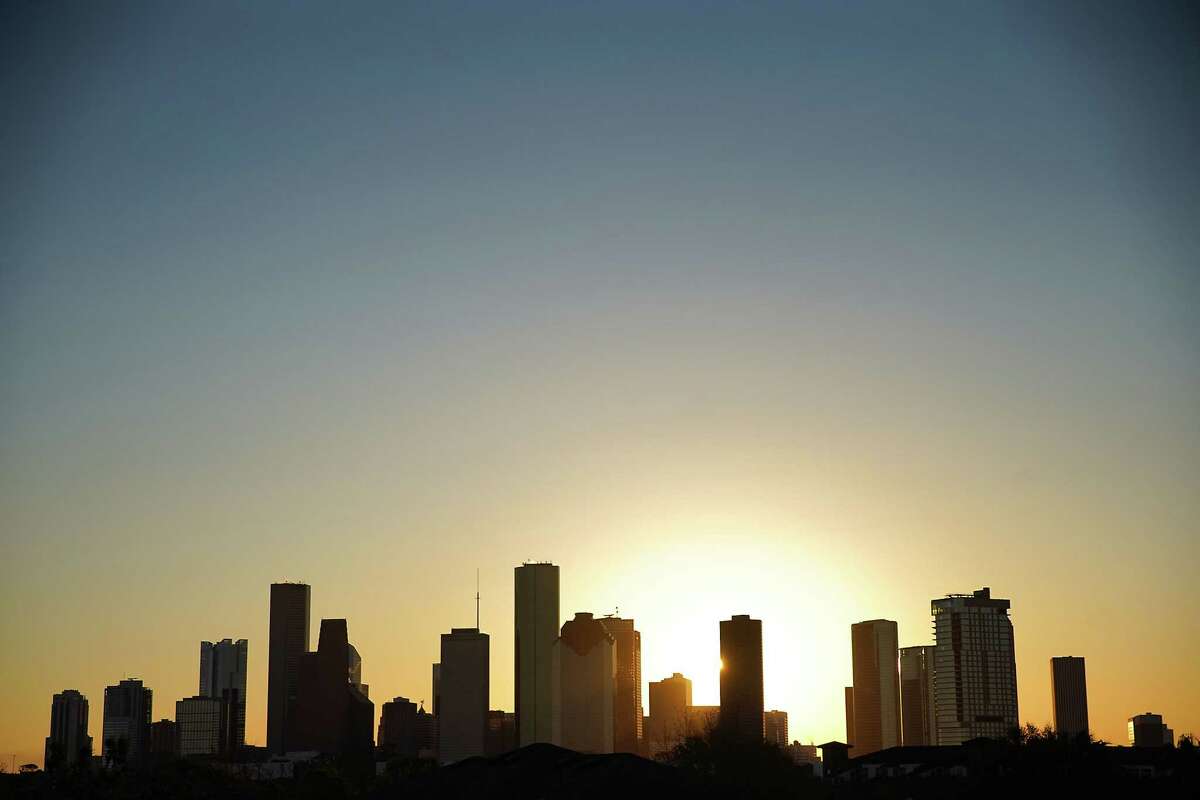 The sunrises behind the Houston skyline as residents wake up to below freezing temperatures on Friday, Dec. 23, 2022 in Houston.