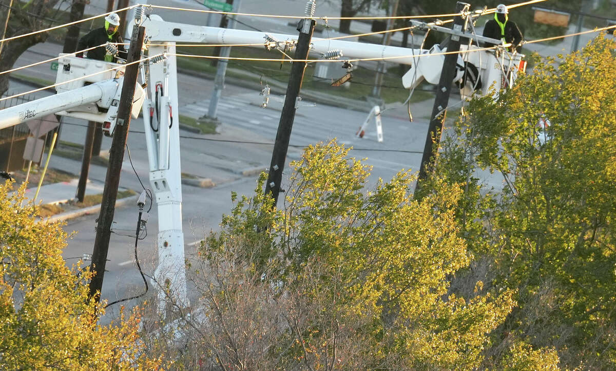 Line crews work on a transformer that was hit by a metro bus, creating a power outage, on Washington and Montrose on Friday, Dec. 23, 2022 in Houston.
