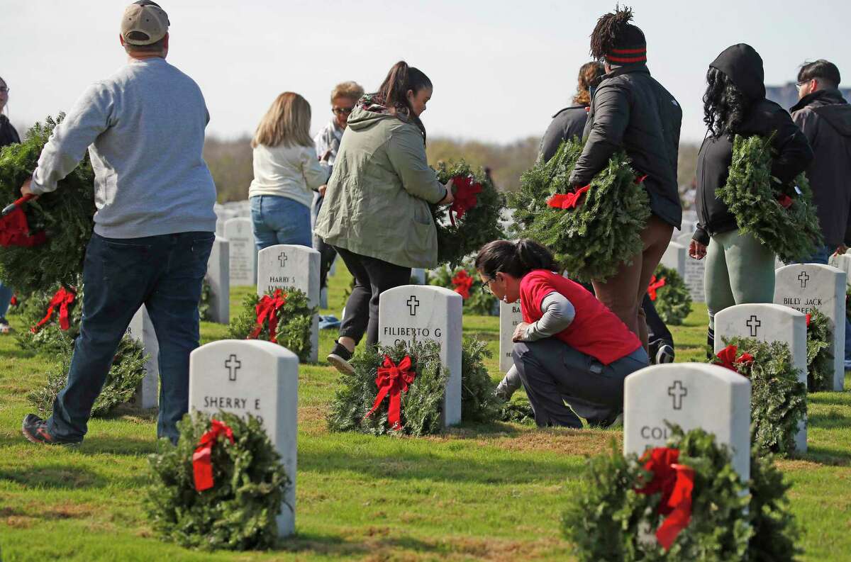 Volunteers lay wreaths at Fort Sam Houston National Cemetery on Dec. 17, pausing to reflect and remember. Every moment — and wreath — was a reminder of the gift of time.