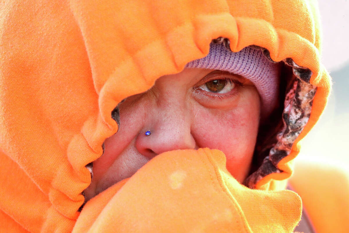 Jennifer Clowe warms her hands and look   successful  14-degree upwind  arsenic  she waits for a Conroe Connection autobus  to instrumentality     her to work, Friday, Dec. 23, 2022, successful  Conroe.