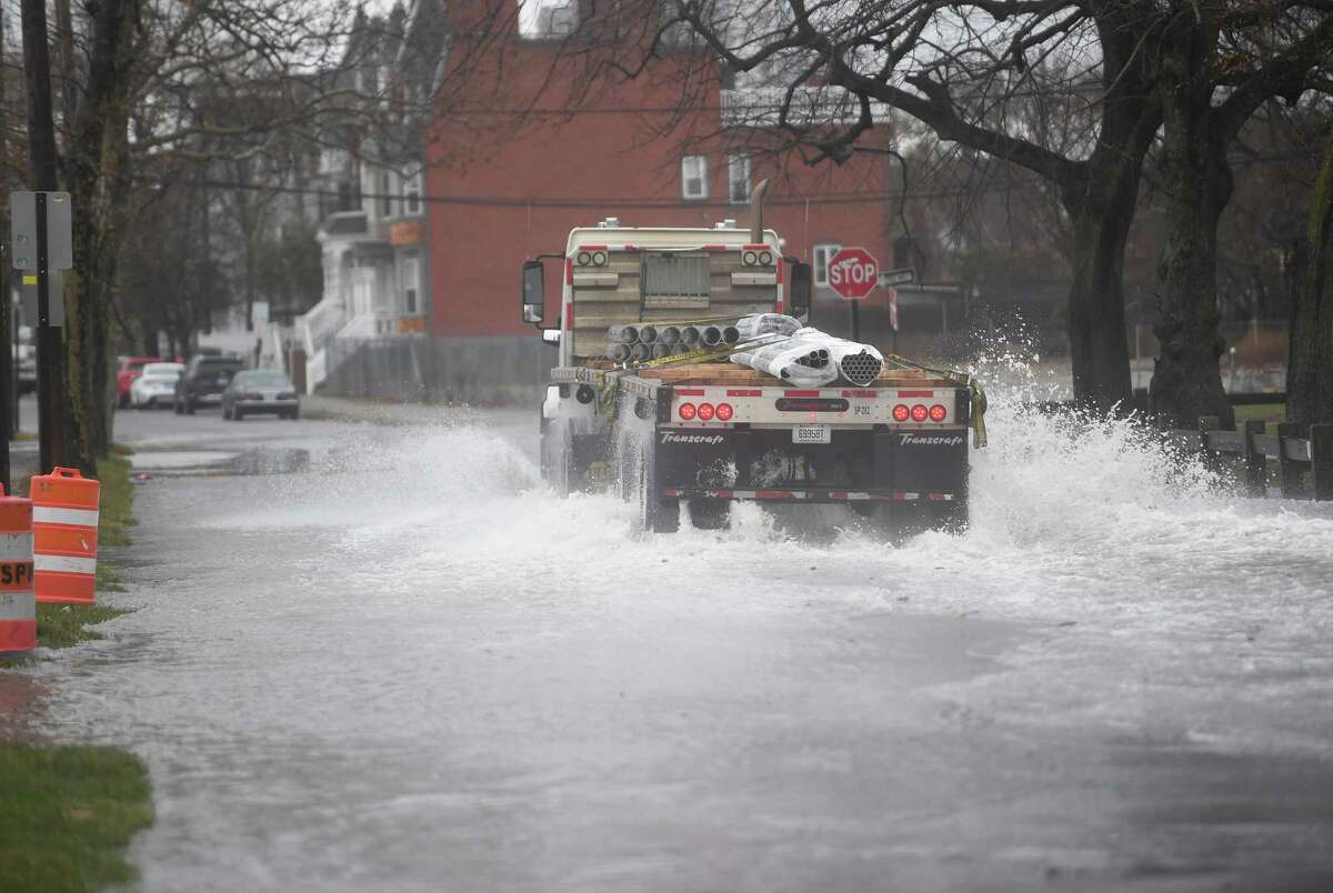 A motortruck  crosses a flooded conception  of Broad Street during the noreaster tempest  successful  Bridgeport, Conn. connected  Friday, December 23, 2022.