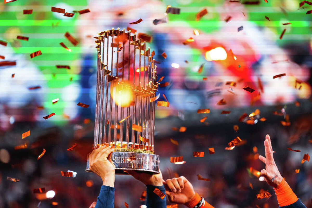 Members of the Houston Astros hoist up the Commissioners Trophy after the Astros defeated the Philadelphia Phillies in Game 6 of the 2022 World Series on November 5, 2022 at Minute Maid Park in Houston.
