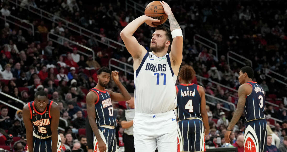 Dallas Mavericks guard Luka Doncic (77) shoots a technical as Houston Rockets players react in the background during the second half of an NBA basketball game at Toyota Center on Friday, Dec. 23, 2022 in Houston.