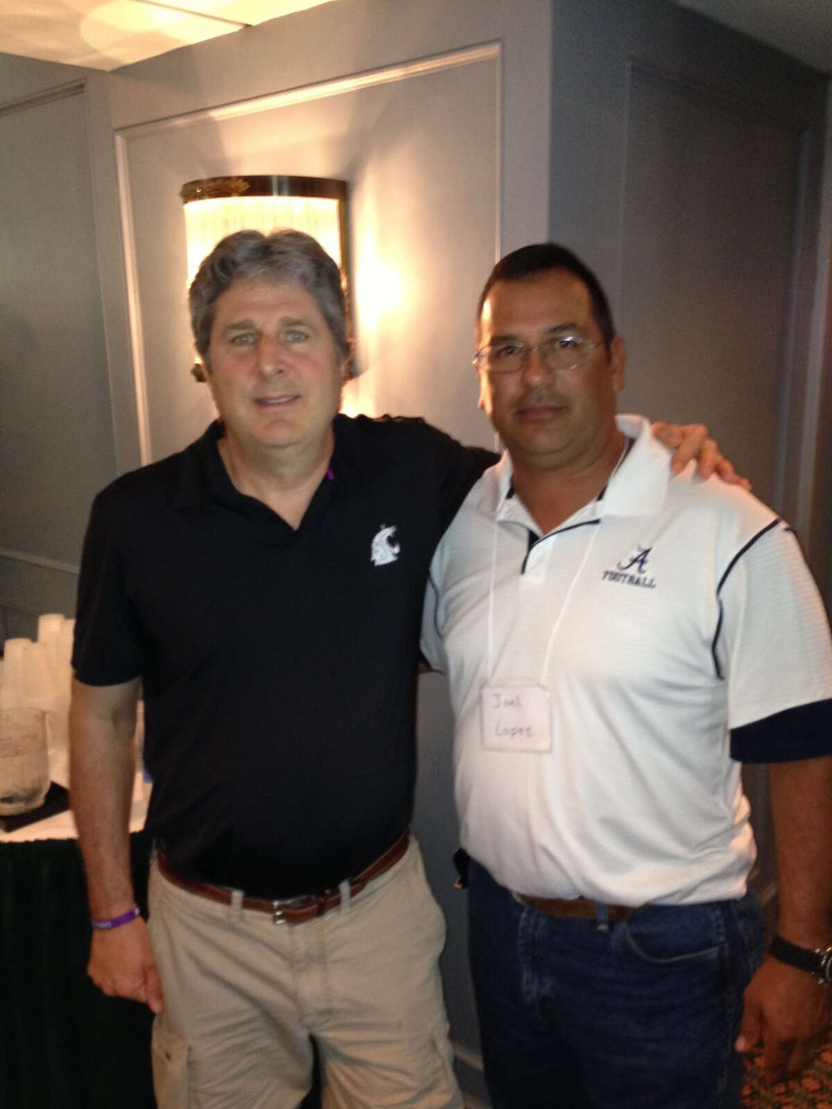 Zapata head coach Joel Lopez with legendary college football coach Mike Leach at a coaching clinic.