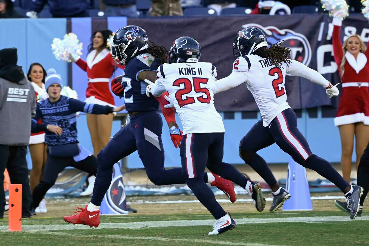 Tennessee Titans running back Derrick Henry (22) runs for a touchdown against Houston Texans cornerback Desmond King II (25) during the first half of an NFL football game, Saturday, Dec. 24, 2022, in Nashville, Tenn. (AP Photo/Mark Zaleski)