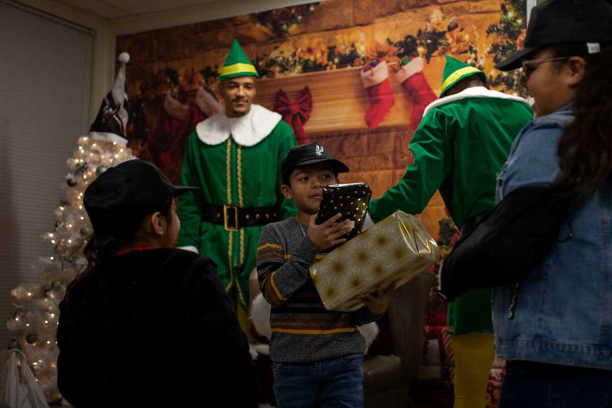 Nathan Alvarado, 7, receives presents from the Spurs players as part of the organization’s “Season of Giving” initiative.