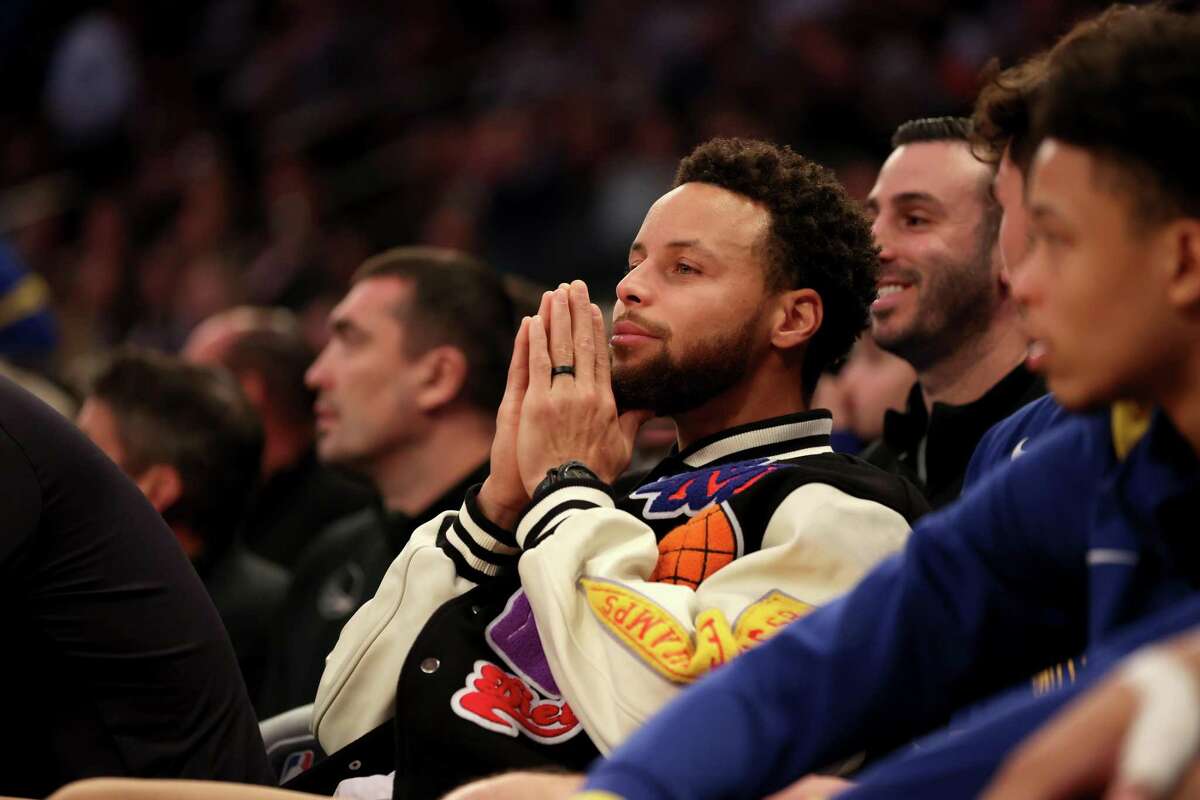 NEW YORK, NEW YORK - DECEMBER 20: Stephen Curry #30 of the Golden State Warriors looks on from the bench during the second quarter of the game against the New York Knicks at Madison Square Garden on December 20, 2022 in New York City. NOTE TO USER: User expressly acknowledges and agrees that, by downloading and/or using this photograph, User is consenting to the terms and conditions of the Getty Images License Agreement. (Photo by Sarah Stier/Getty Images)