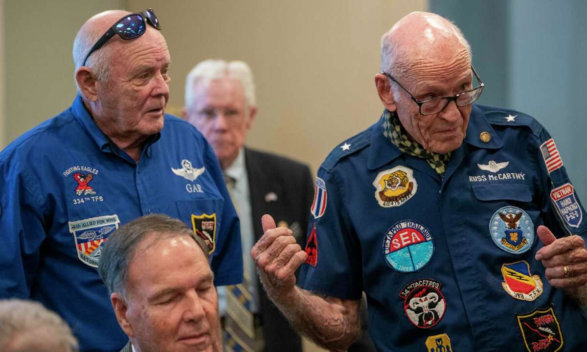 Retired Air Force Lt. Col. George Alan Rose, who was shot down during Operation Linebacker II, left, listens to retired Air Force Brig. Gen. Russ McCarthy, during a presentation reflecting on the 50th anniversary of Linebacker II, one of the most high-profile air missions of the Vietnam War at Blue Skies of Texas retirement community in San Antonio on Tuesday, Dec. 14.