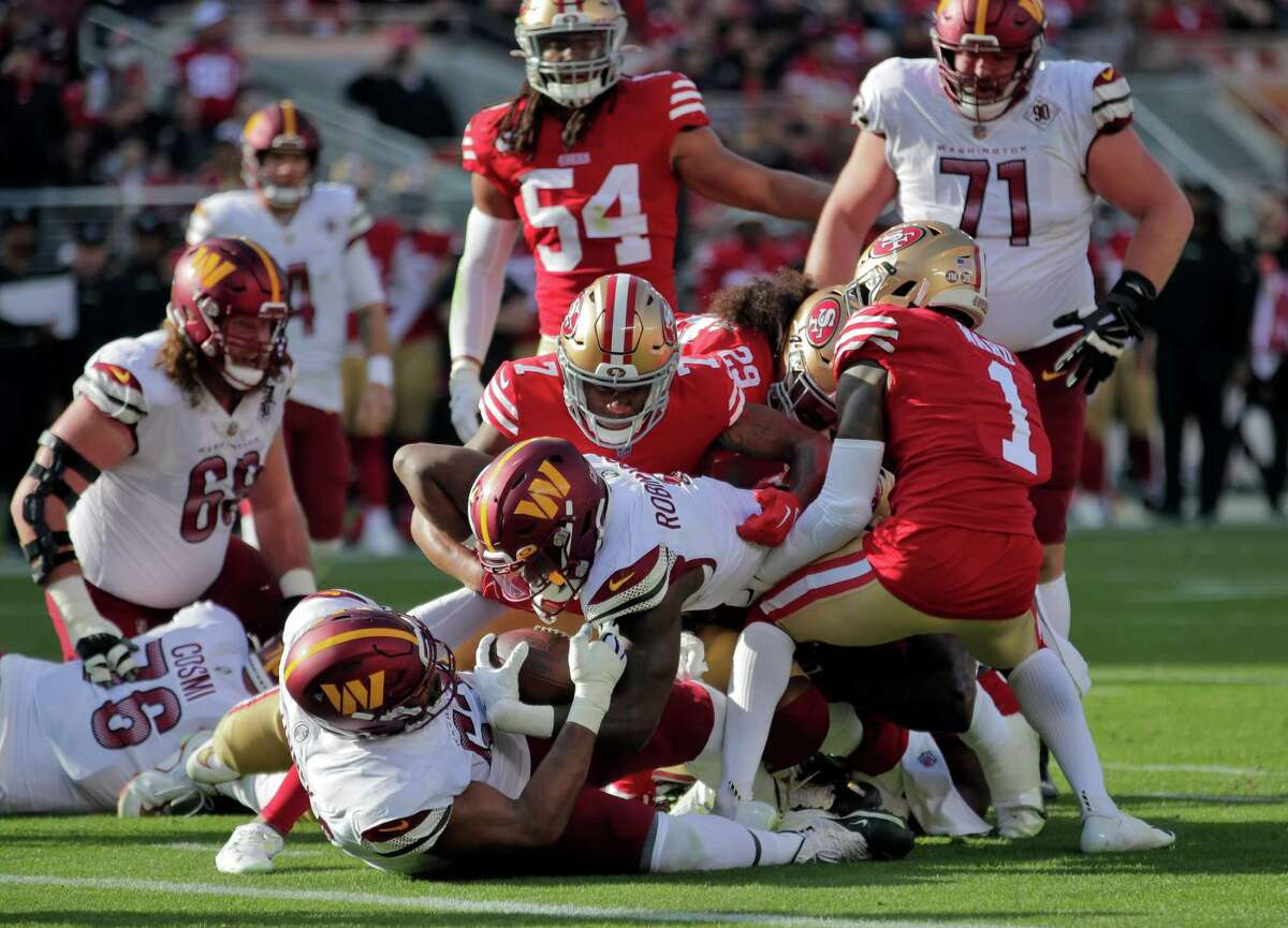 49ers defense holds Brian Robinson Jr. (8) in a goal line stand in the first half as the San Francisco 49ers played the Washington Commanders at Levi’s Stadium in Santa Clara, Calif., on Saturday, December 24, 2022.