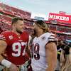 Nick Bosa (97) chats with Washington’s Chase Young, a former Ohio State teammate, after the San Francisco 49ers dereated the Washington Commanders at Levi’s Stadium in Santa Clara, Calif., on Saturday, December 24, 2022. The 49ers defeated the Commanders 37-20.