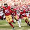 San Francisco 49ers tight end George Kittle (85) rushes for a touchdown during the second half of his NFL football game against Washington Commanders in Santa Clara, Calif., Saturday, Dec. 24, 2022. The 49ers defeated the Commanders 37-20.