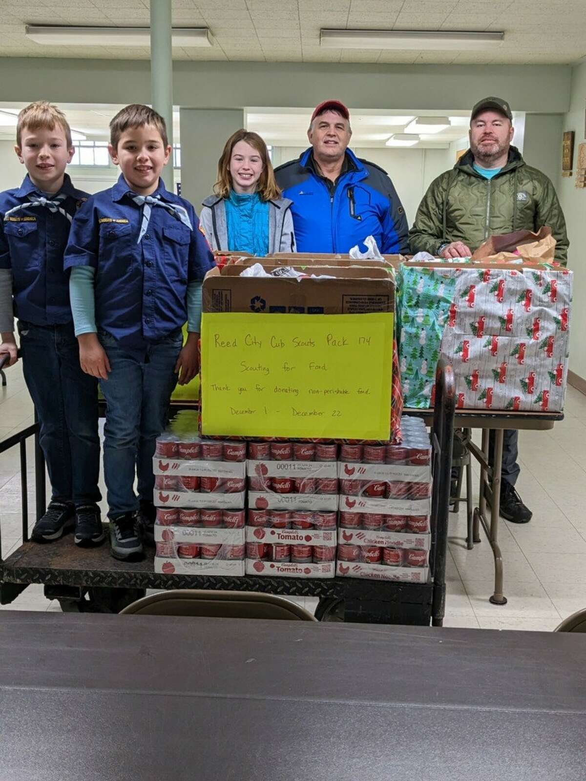 Reed City BSA Pack 174 recently completed their 2022 Scouting for Food campaign, donating collected items to Project Starburst Food Pantry. Pictured (left to right) are Bear Scouts Sean & Evan Brummeler, Margaret Brummeler, Charles Brummeler and Scout Leader Russ Nehmer.  